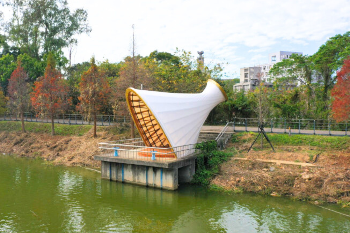 The bamboo structure, "Jhu Syuan Huan Jyu(竹旋幻居)," is presented on the flood control terrace of the Guangfu campus at NYCU, showcasing the beauty of bamboo architecture.