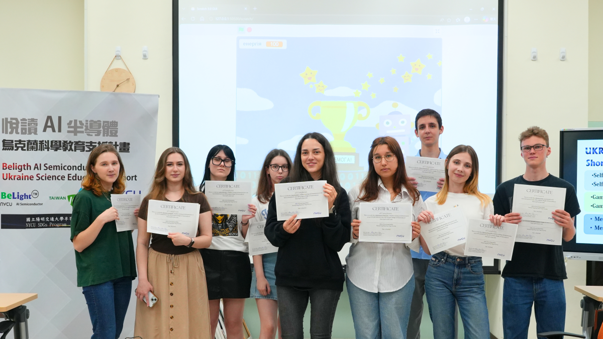 Ukrainian students present games they designed through the program and pose for a group photo with their certificates following the project showcase.
