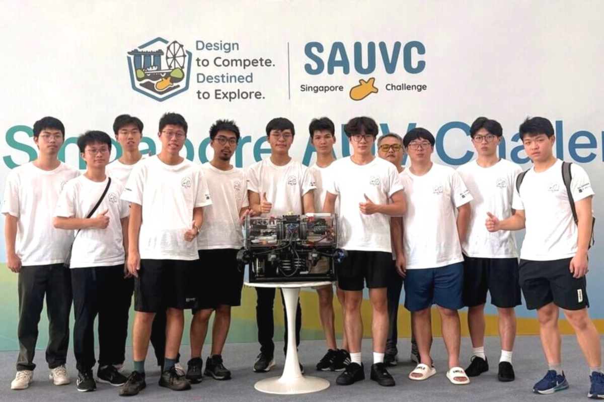 The ORCA AUV Team poses with its autonomous underwater vehicle at the 2026 Singapore Autonomous Underwater Vehicle Challenge.