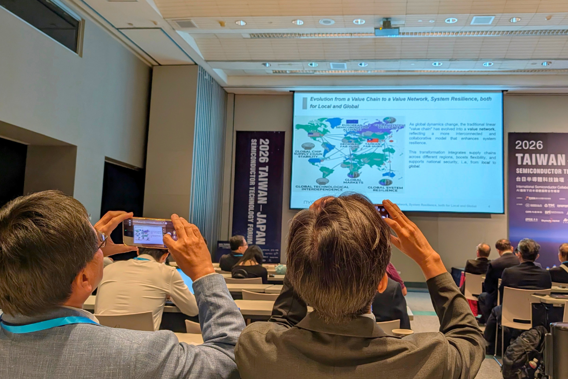 Attendees photograph a presentation by Yuan-Chieh Tseng on NYCU’s “ecosystem university” model at the 2026 Taiwan-Japan Semiconductor Technology Forum.